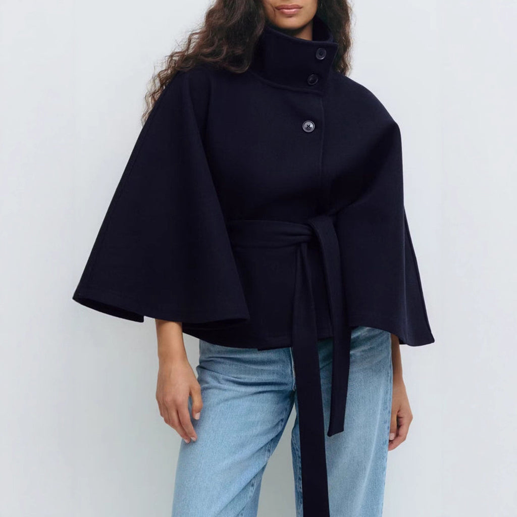 Detailed shot of the high neck and button top closure on the elegant women's coat.
