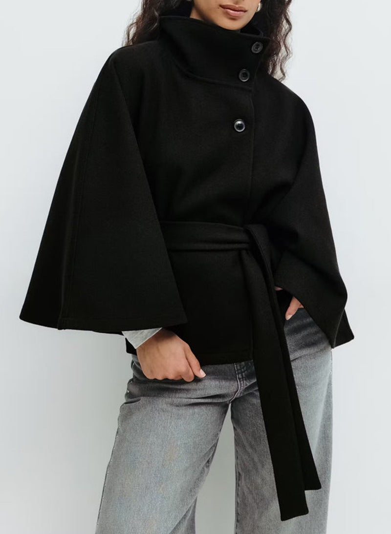 Full-body view of the loose fit trench coat worn unbelted to show its relaxed, elegant drape.