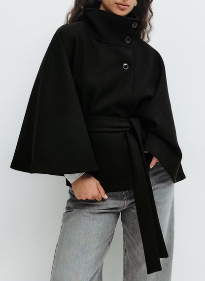 Full-body view of the loose fit trench coat worn unbelted to show its relaxed, elegant drape.