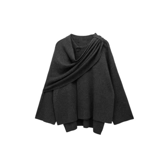 Studio shot of the women's loose knitted cape sweater coat, neatly folded.